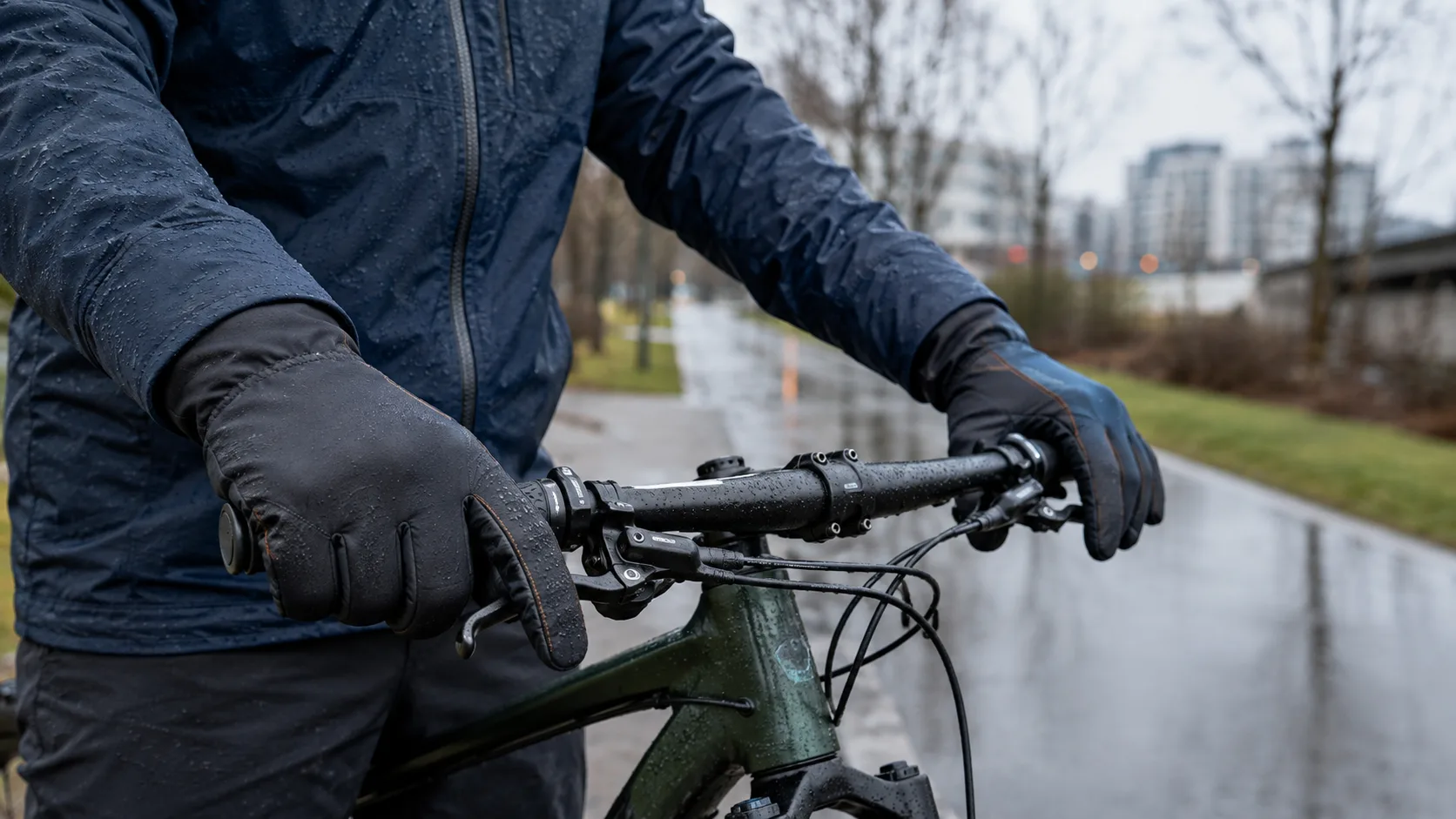 Insulated waterproof cycling gloves covering the cuffs during a cold wet ride